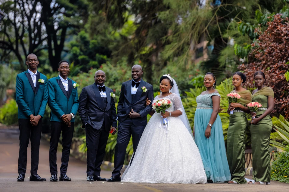 Bride and groom with their wedding party in a lush garden